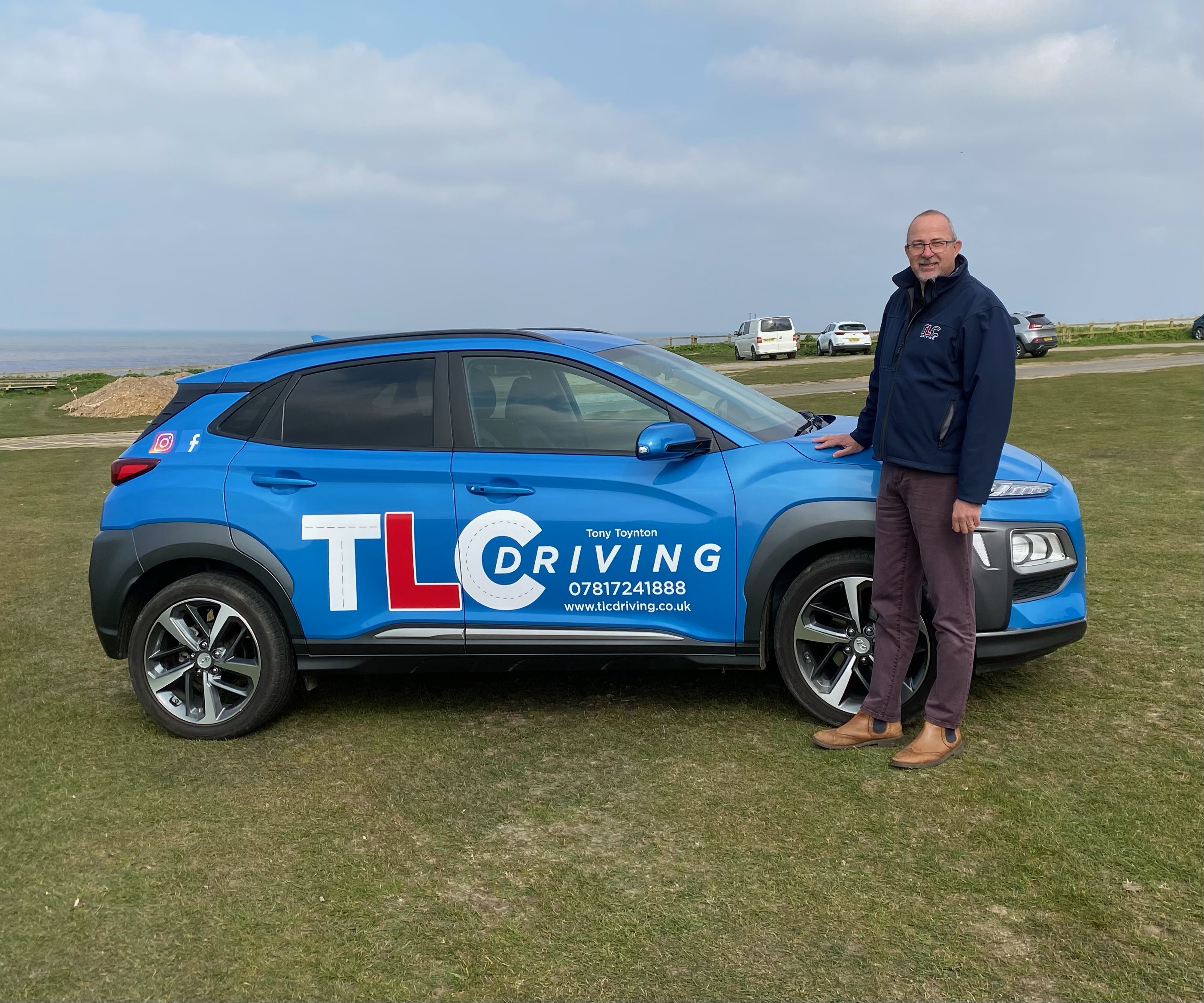 Tony Toynton stood next to his car